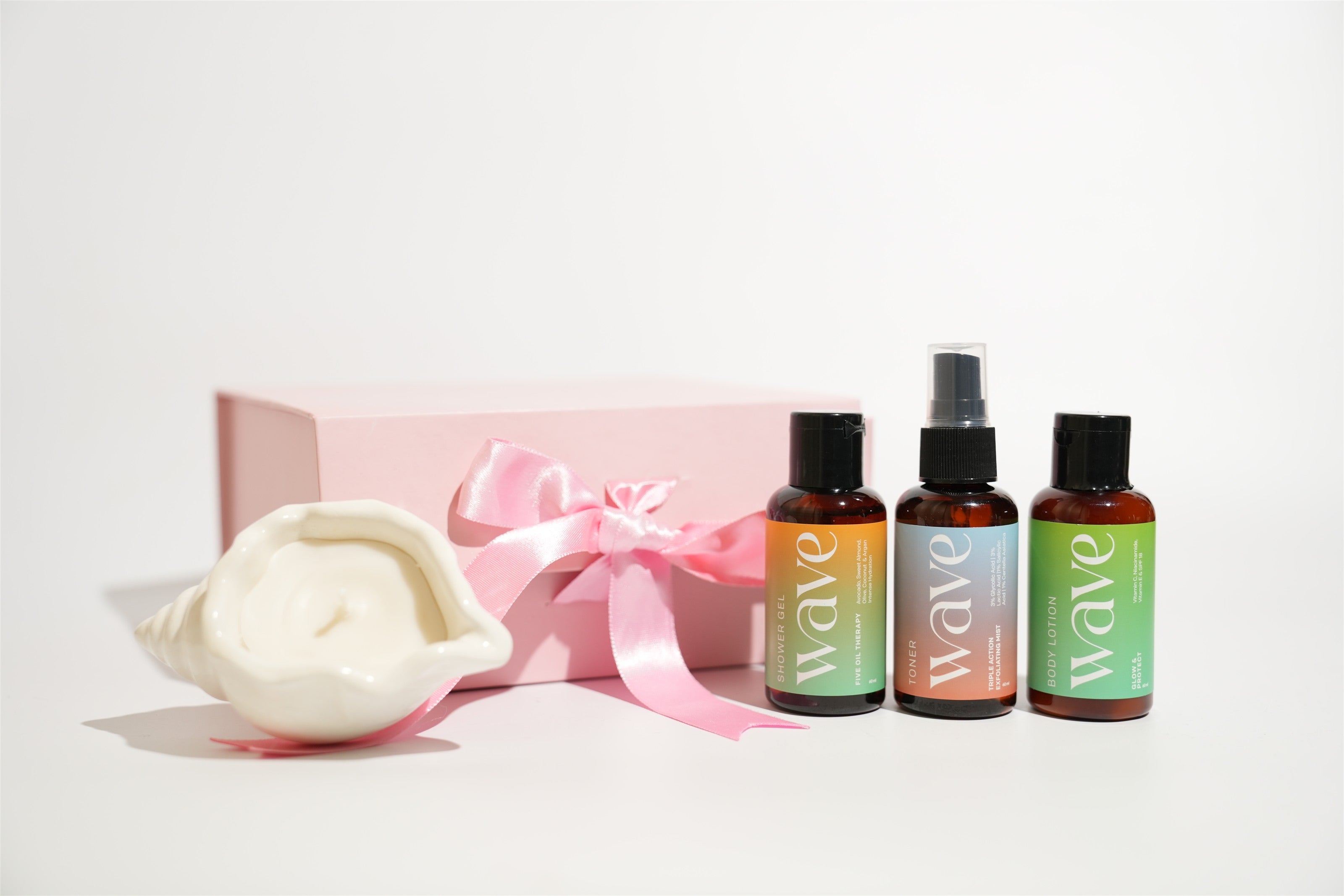 Wave mini bodycare and a seashell candle presented in a pink gift box